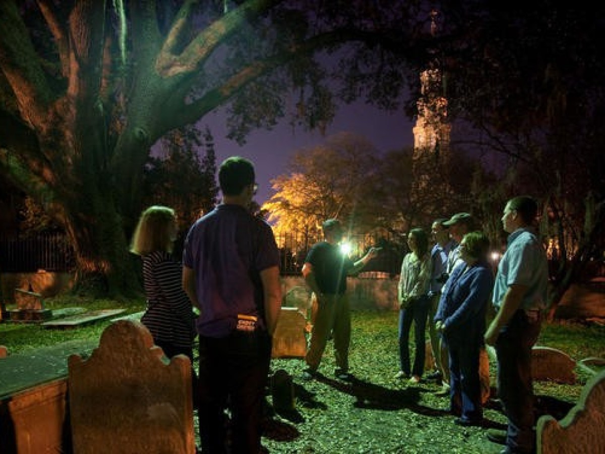 a group of people that are standing in the grass